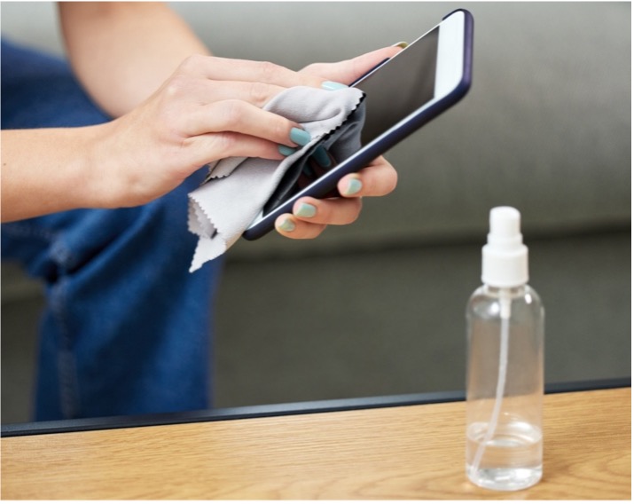 A person cleaning a phone